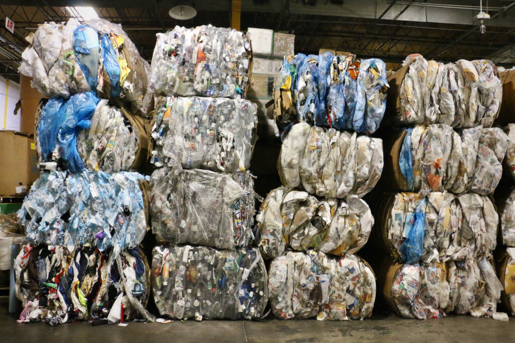 Bundles of items are stacked in TerraCycle's sorting facility in New Brunswick. (Emma Lee/WHYY)