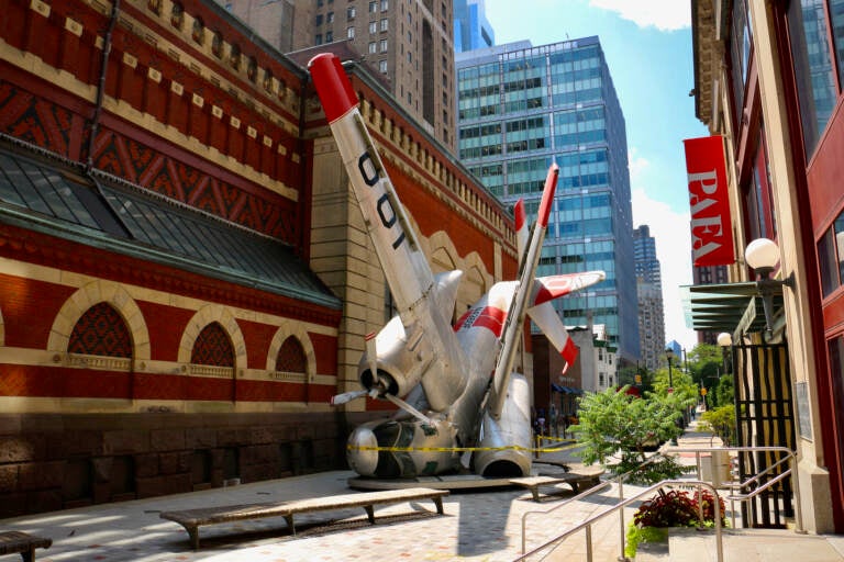 ''Grumman Greenhouse'' has occupied Lenfest Plaza at the Pennsylvania Academy of Fine Arts since 2011. The sculpture features a Navy war plane that has been converted into a greenhouse. (Emma Lee/WHYY)