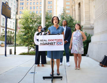 Dr. Val Arkoosh,(left), Chair of Montgomery County Board of Commissioners, speaks outside Philadelphia City Hall, where she helped launch the Real Doctors Against Oz campaign. The campaign is directed against Republican Senate candidate Mehmet Oz and is financed by his opponent, Democratic Lieutenant Gov. John Fetterman. (Emma Lee/WHYY)