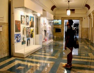 File photo: Portraits of loved ones of shooting victims, called co-victims, are displayed on three floors at Philadelphia City Hall in an exhibit curated by Zarinah Lomax called ''We Are Here: Stories and Expressions of Healing.'' (Emma Lee/WHYY)