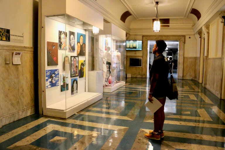 File photo: Portraits of loved ones of shooting victims, called co-victims, are displayed on three floors at Philadelphia City Hall in an exhibit curated by Zarinah Lomax called ''We Are Here: Stories and Expressions of Healing.'' (Emma Lee/WHYY)