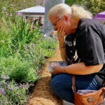 Terri Spina chokes back tears after placing a marker for her daughter in the Philadelphia Overdose Memorial Garden. (Emma Lee/WHYY)