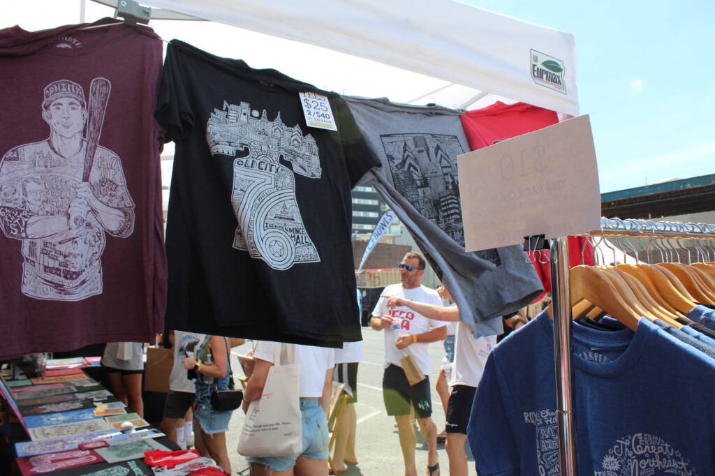 T-shirts are displayed at a tent.