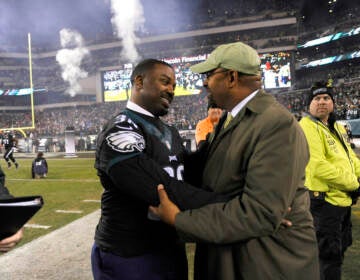 Former Philadelphia Eagles player Brian Westbrook, left, talks to Philadelphia Mayor Michael Nutter prior to an NFL football game, Monday, Oct. 19, 2015, in Philadelphia. (AP Photo/Michael Perez)