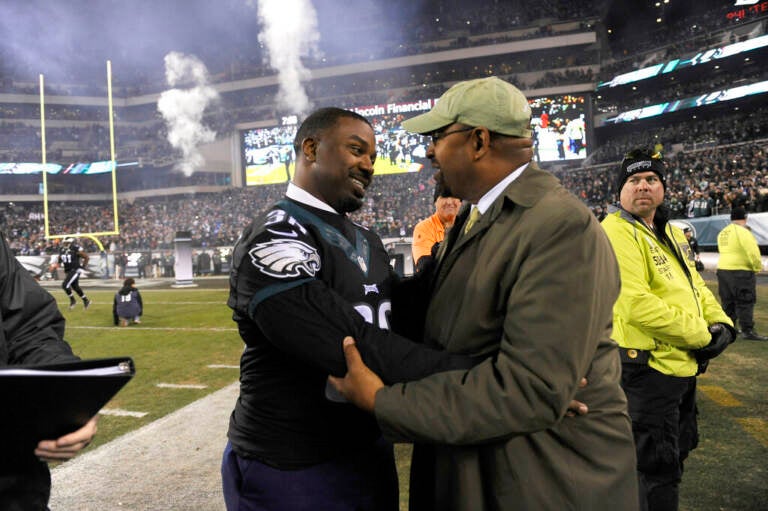 Former Philadelphia Eagles player Brian Westbrook, left, talks to Philadelphia Mayor Michael Nutter prior to an NFL football game, Monday, Oct. 19, 2015, in Philadelphia. (AP Photo/Michael Perez)