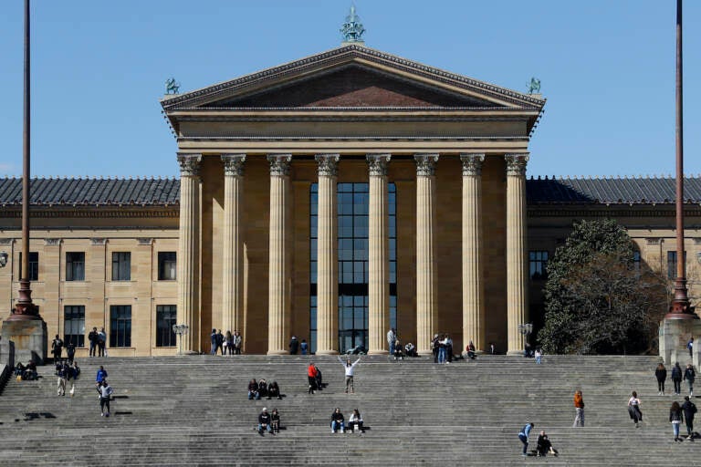 People gather on the steps of the Philadelphia Art Museum, Sunday, March 15, 2020, in Philadelphia. (AP Photo/Matt Slocum)