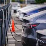 A group of cars line up at charging stations
