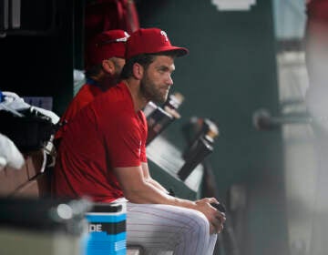 File photo: Philadelphia Phillies Bryce Harper sits in the dugout during the eighth inning of a baseball game against the Chicago Cubs, Saturday, July 23, 2022, in Philadelphia. (AP Photo/Matt Rourke)
