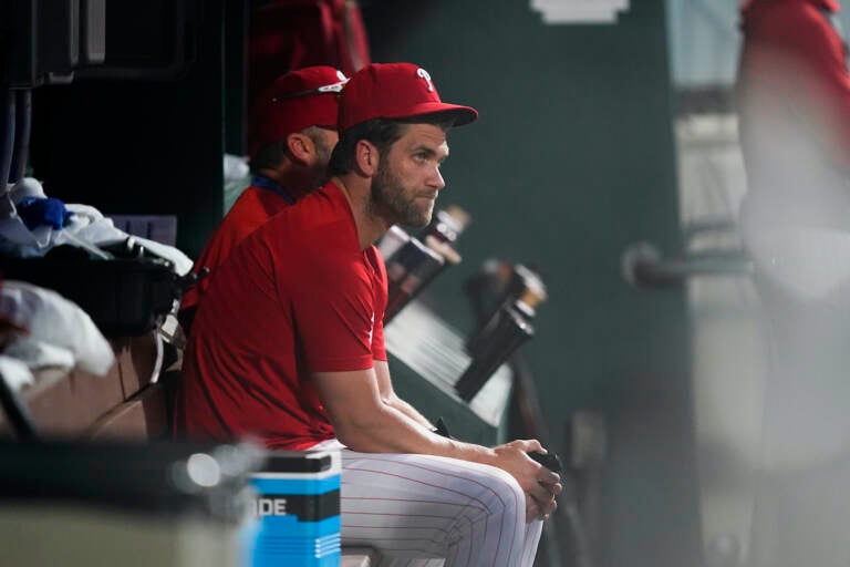 File photo: Philadelphia Phillies Bryce Harper sits in the dugout during the eighth inning of a baseball game against the Chicago Cubs, Saturday, July 23, 2022, in Philadelphia. (AP Photo/Matt Rourke)