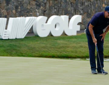 Phil Mickelson lines up a shot on the 18th hole during the first round of the Bedminster Invitational LIV Golf tournament in Bedminster, N.J., Friday, July 29, 2022. (AP Photo/Seth Wenig)