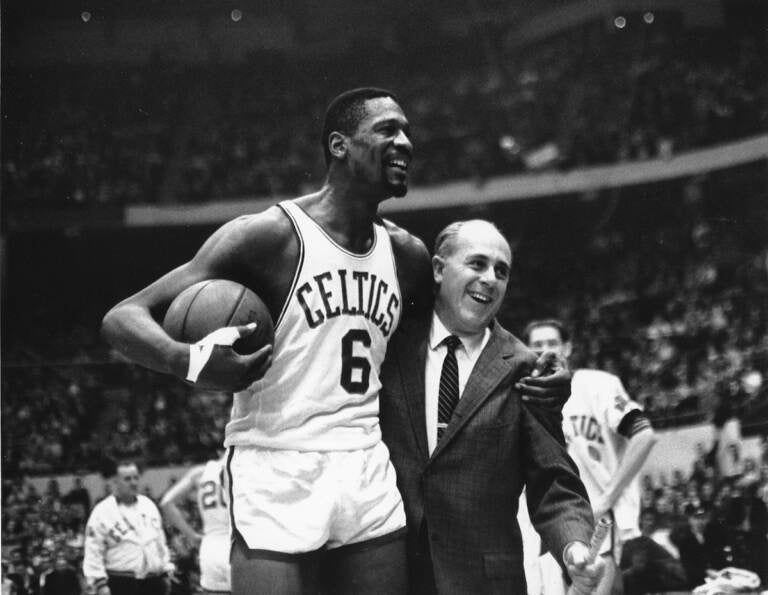 File photo: Bill Russell, (left) star of the Boston Celtics is congratulated by coach Arnold ''Red'' Auerbach after scoring his 10,000th point in the NBA game against the Baltimore Bullets in Boston Garden on Dec. 12, 1964. (AP Photo/Bill Chaplis, file)