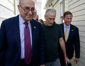 Jon Steward (center) walks with Senate Majority Leader Chuck Schumer of N.Y. (left) and Sen. Richard Blumenthal, D-Conn., to a news conference after the Senate passed a bill designed to help millions of veterans exposed to toxic substances during their military service, Tuesday, Aug. 2, 2022, on Capitol Hill in Washington. (AP Photo/Patrick Semansky)