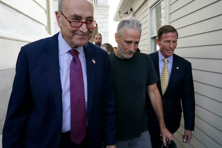 Jon Steward (center) walks with Senate Majority Leader Chuck Schumer of N.Y. (left) and Sen. Richard Blumenthal, D-Conn., to a news conference after the Senate passed a bill designed to help millions of veterans exposed to toxic substances during their military service, Tuesday, Aug. 2, 2022, on Capitol Hill in Washington. (AP Photo/Patrick Semansky)