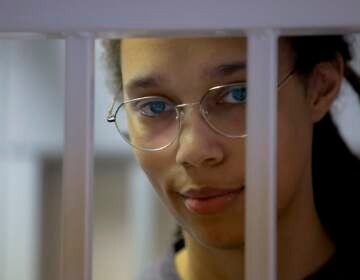 WNBA star and two-time Olympic gold medalist Brittney Griner stands in a cage in a courtroom prior to a hearing in Khimki just outside Moscow, Russia, Thursday, Aug. 4, 2022. Closing arguments in Brittney Griner's cannabis possession case are set for Thursday, nearly six months after the American basketball star was arrested at a Moscow airport in a case that reached the highest levels of US-Russia diplomacy. (Evgenia Novozhenina/Pool Photo via AP)