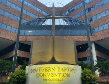 File photo: A cross and Bible sculpture stand outside the Southern Baptist Convention headquarters in Nashville, Tenn., on May 24, 2022. The Executive Committee of the Southern Baptist Convention said Friday, Aug. 12, 2022, that several of the denomination's major entities are under investigation by the U.S. Department of Justice. (AP Photo/Holly Meyer, File)