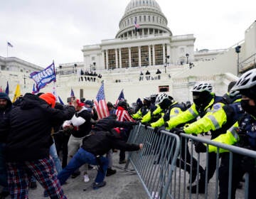 Rioters push a police barricade at the U.S. Capitol on Jan. 6, 2021.