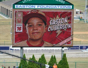 File photo: A picture of Mountain Region Champion Little League team member Easton Oliverson, from Santa Clara, Utah, is shown on the scoreboard at Volunteer Stadium during the opening ceremony of the 2022 Little League World Series baseball tournament in South Williamsport, Pa., Wednesday, Aug 17, 2022. Oliverson was injured when he fell out of a bunk bed at the dormitory complex. (AP Photo/Gene J. Puskar)