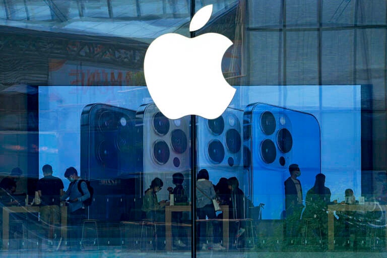 File photo: People shop at an Apple Store in Beijing, Tuesday, Sept. 28, 2021. (AP Photo/Andy Wong, File)