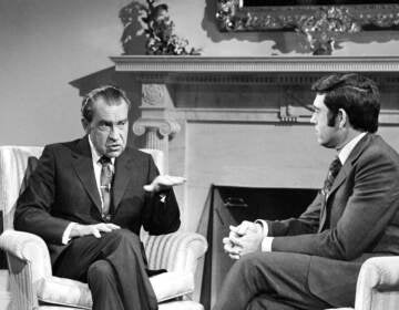 President Richard Nixon talks with correspondent Dan Rather before an interview at the White House in Washington, Jan. 2, 1972. (AP Photo/Harvey Georges)