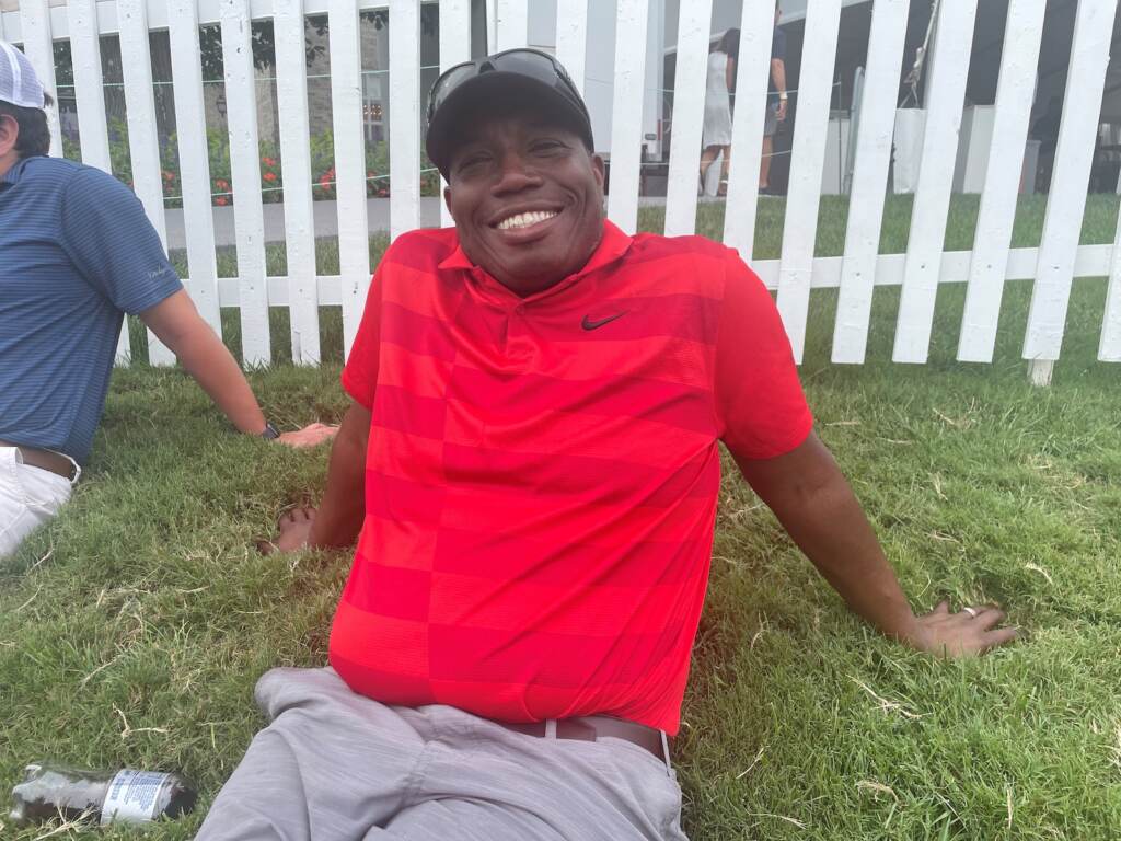 Garrard Gray sits on the grass at the PGA tour in Wilmington