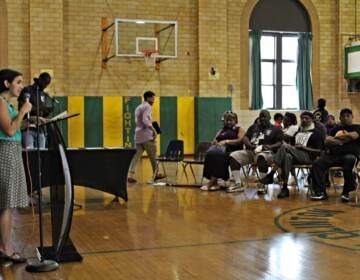 Gun violence and prevention reporter Sammy Caiola moderated a community conversation at St. Gabriel's Auditorium in South Philadelphia on Aug. 24, 2022. (Cory Sharber/WHYY)