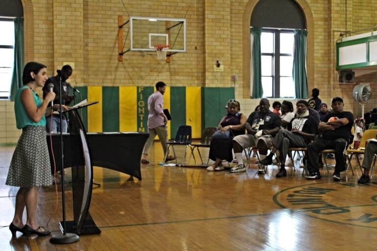 Gun violence and prevention reporter Sammy Caiola moderated a community conversation at St. Gabriel's Auditorium in South Philadelphia on Aug. 24, 2022. (Cory Sharber/WHYY)