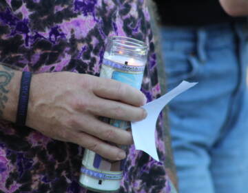 During the candlelight vigil, names of loved ones were read aloud through a megaphone. (Cory Sharber/WHYY)