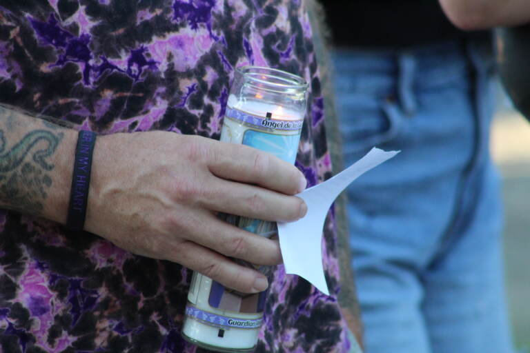 During the candlelight vigil, names of loved ones were read aloud through a megaphone. (Cory Sharber/WHYY)