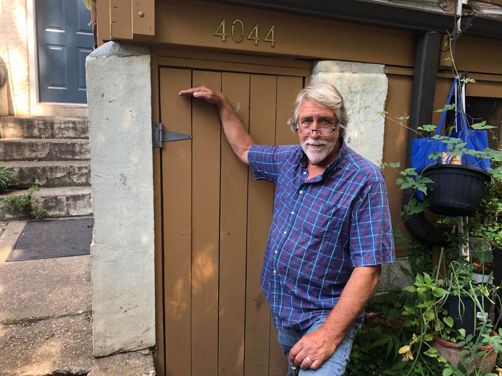 Nelson Haakenson points to the level water reached on his basement door from the remnants of Hurricane Ida.