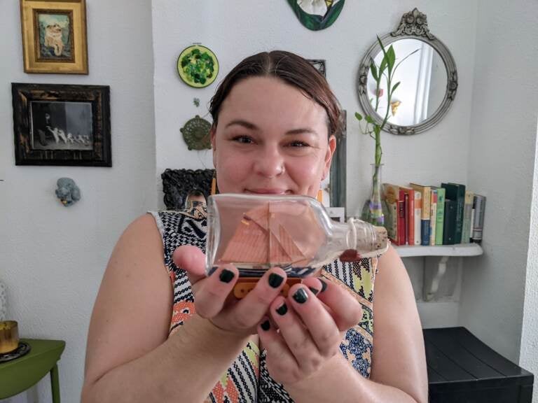 Tanya Mayeux, who manages the StoopingPHL Instagram account, says her favorite thing she's ever found is a small ship in a glass bottle. (Elizabeth Estrada/WHYY)