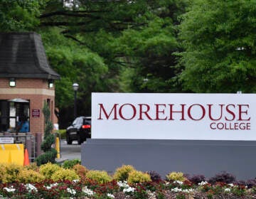 A sign reads Morehouse College, with green trees in the background.