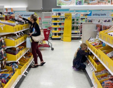 A parent shops for school supplies deals at a Target store