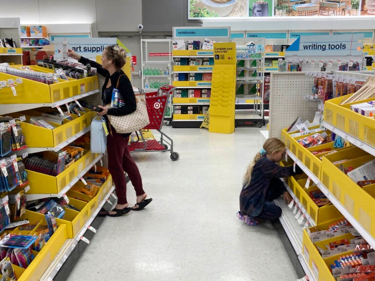 A parent shops for school supplies deals at a Target store