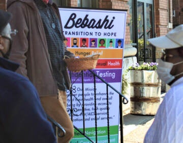 People stand in front of a sign that reads Bebashi.