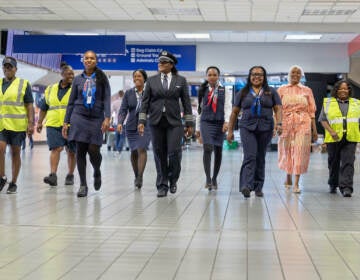 A Black, woman-led crew walks at the airport