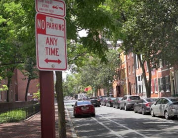 Car parked in a bike lane in Philly. (WHYY)