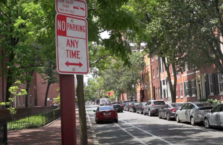 Car parked in a bike lane in Philly. (WHYY)