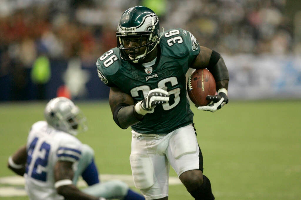 Philadelphia Eagles running back Brian Westbrook runs with the ball as Dallas Cowboys cornerback Terence Newman sits on the turf