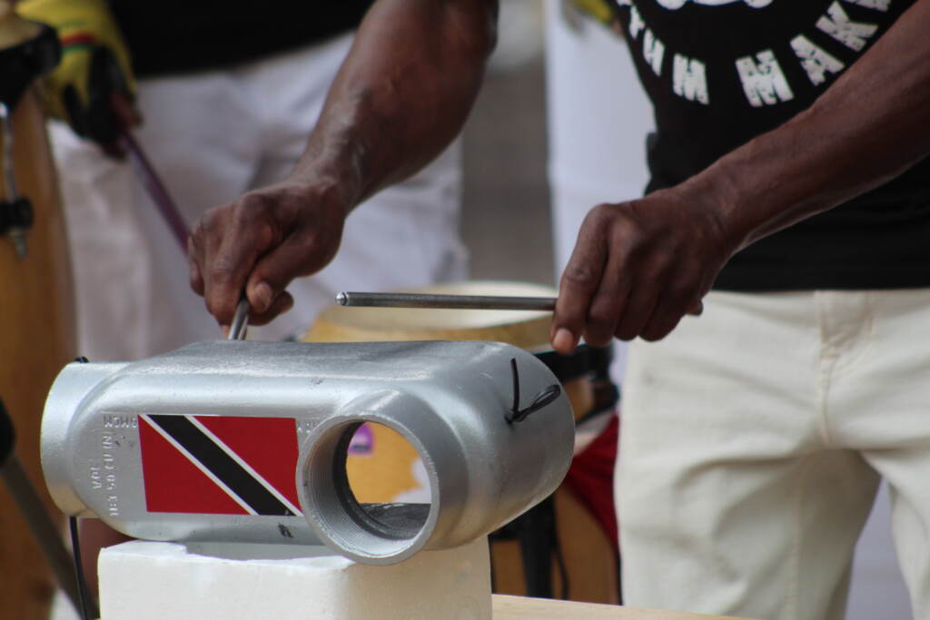 A close-up of hands gripping drumstricks, playing an instrument.