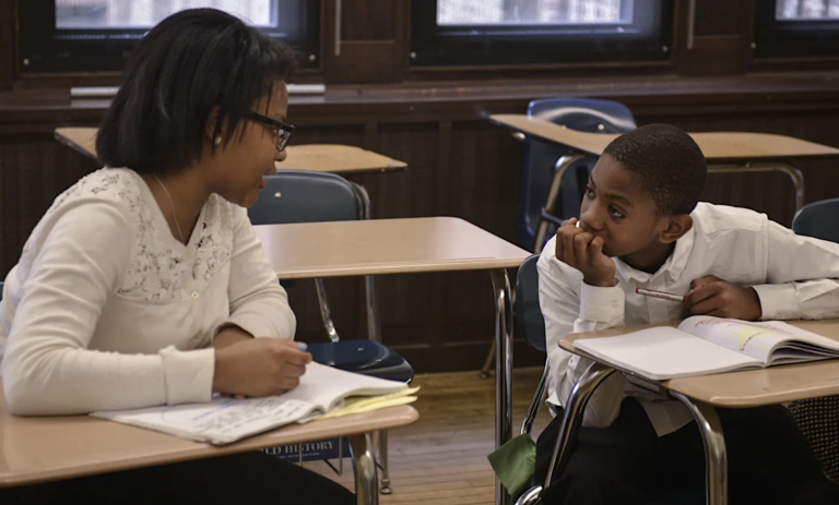 A student and teacher at Philadelphia’s Academy at Palumbo, a school that uses selective admissions. In 2021, the city district changed the system for admissions to the top-tier schools to a lottery process. (Charles Mostroller / The Notebook)