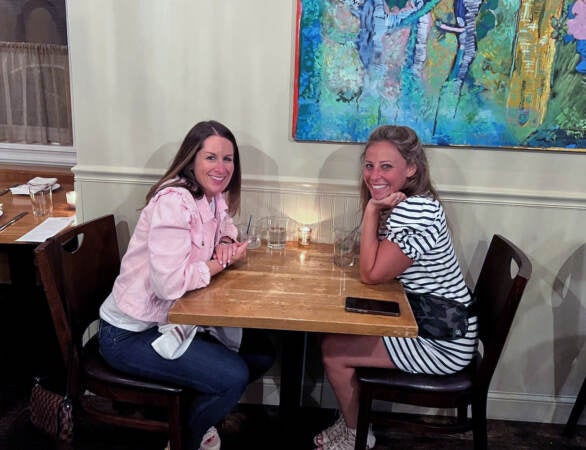 Alison Cohen (left) and Lori Connolly sit at a table inside a Wilmington restaurant