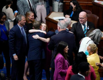 Members of the House of Representatives gather in the chamber to celebrate after the vote to approve the Inflation Reduction Act at the Capitol in Washington, Friday, Aug. 12, 2022. A divided Congress gave final approval Friday to Democrats' flagship climate and health care bill. The House used a party-line 220-207 vote to pass the legislation. (AP Photo/Patrick Semansky)