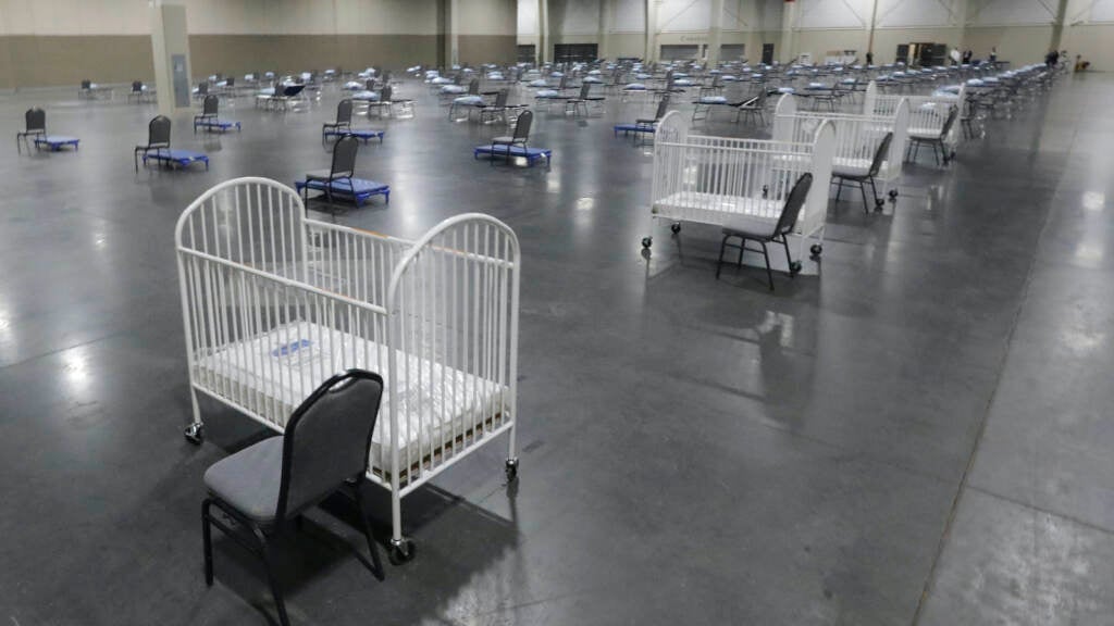 Cots and cribs are arranged at the Mountain America Expo Center