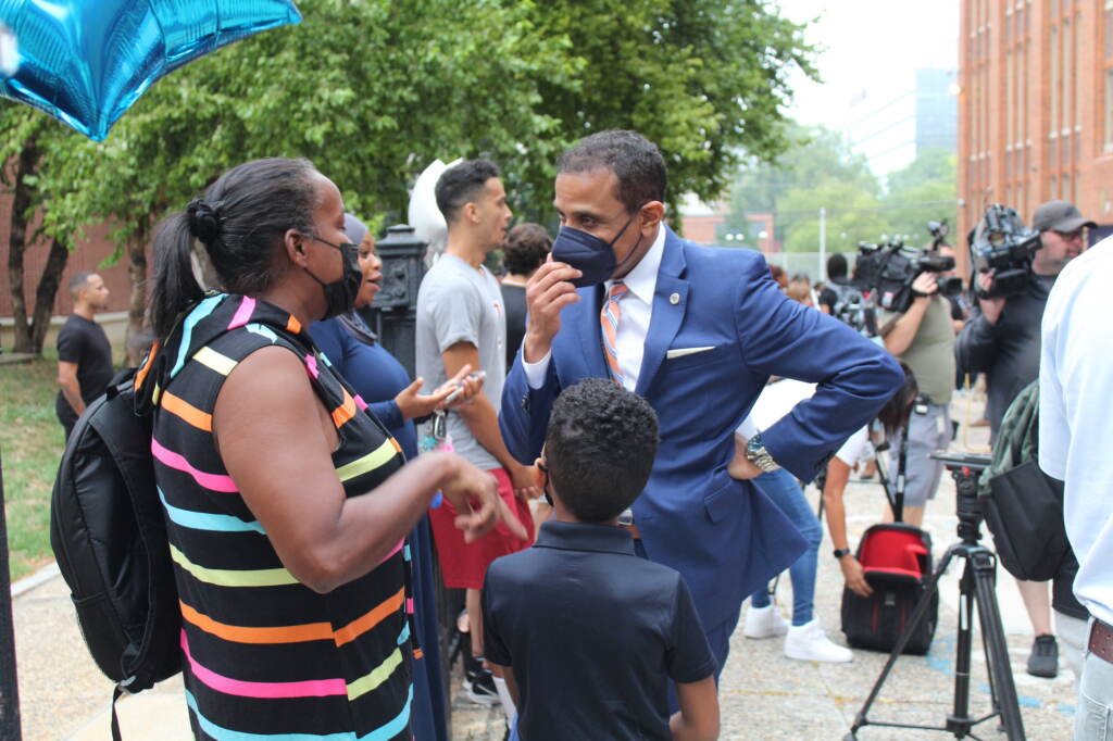 Philadelphia School Superintendent Tony Watlington talks to a parent and student outside of Paul L. Dunbar Elementary School in North Philadelphia on the first day of the school year on August 29, 2022.