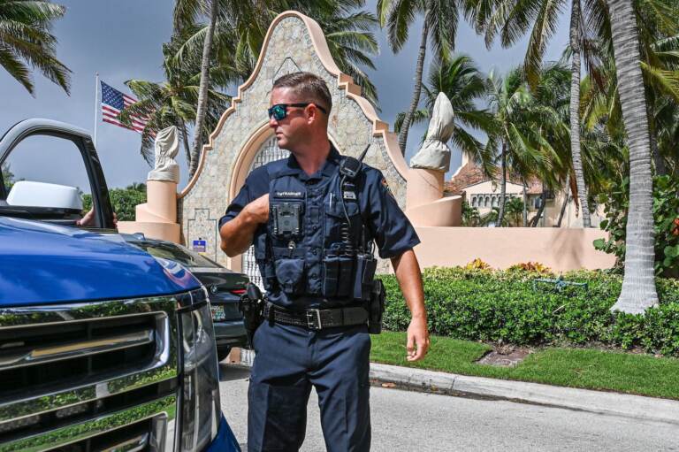 Local law enforcement officers are seen in front of the home of former President Donald Trump at Mar-a-Lago in Palm Beach, Fla.