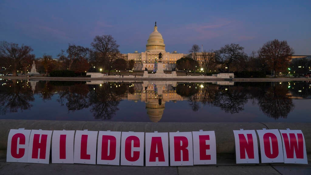Childcare Now is spelled out on signs at the U.S. Capitol