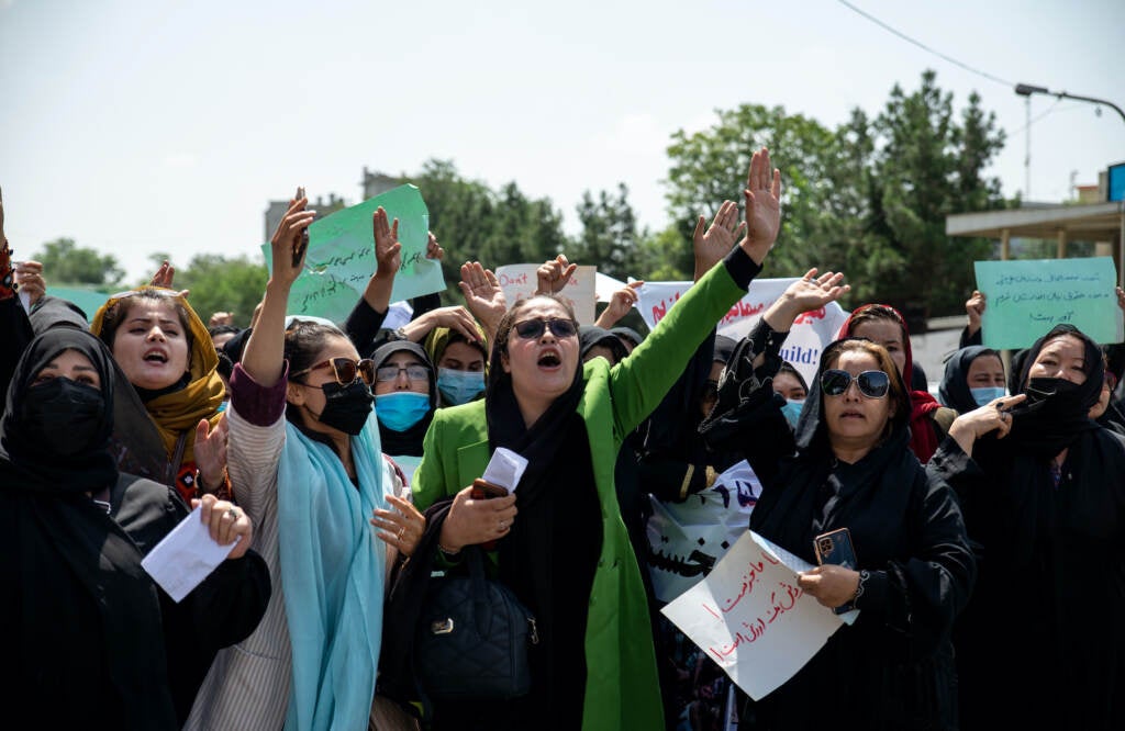 Women chant "Bread, work, freedom" and march in front of the education ministry building in Kabul