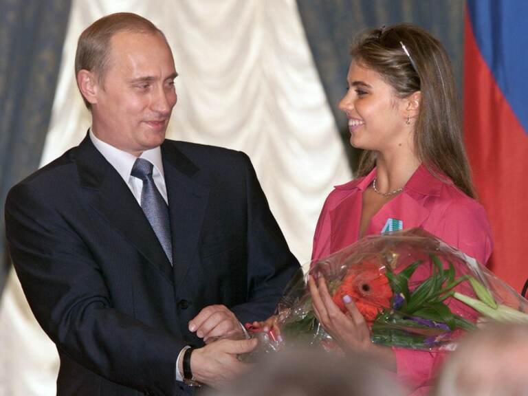 Russian President Vladimir Putin hands flowers to Alina Kabaeva after awarding her with an Order of Friendship during a ceremony at the Kremlin in June 2001. (Sergei Chirikov/AFP via Getty Images)