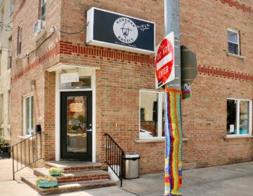 A view of the exterior of Korshak Bagels, a red brick building.