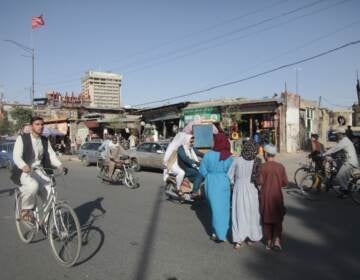 Kabul is seen with men and boys on rickety bicycles